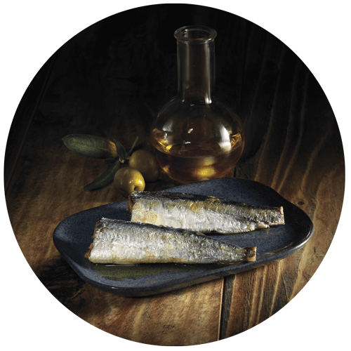 sardines à l'huile d'olive dans une petite assiette bleue et fiole d'huile d'olive pris par un photographe culinaire packaging pour la gamme terroir Auchan